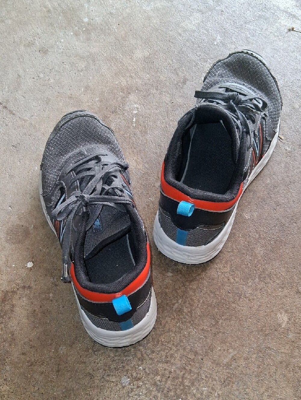 Boys New Balance Charcoal Athletic Sneakers with Red Accent and Blue Heel Tab